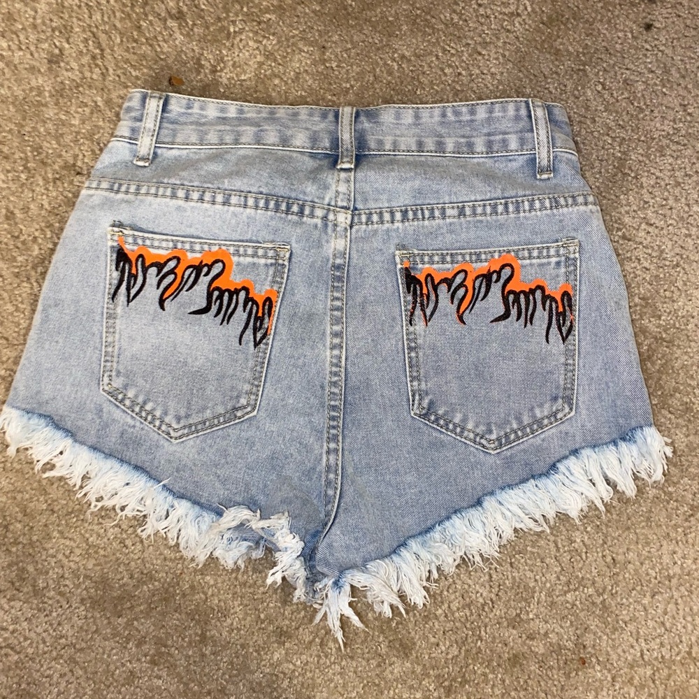 Light wash short with flames of back pockets size 4